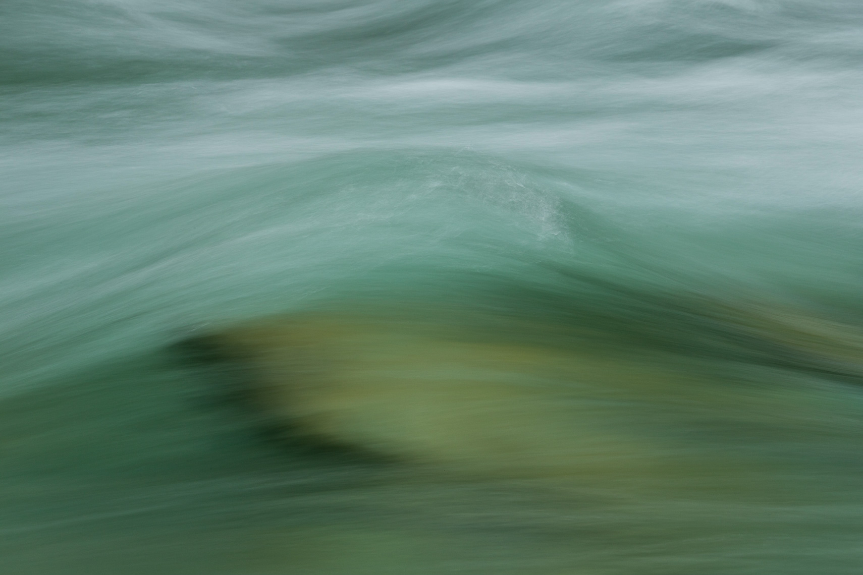 Close up of the flow of water over a river bed by Paul Green Photographer